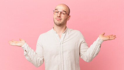 bald man feeling puzzled and confused, doubting, weighting or choosing different options with funny...