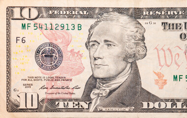 Close-up 10 US dollar banknotes, obverse ten dollar banknote depicting portrait American statesman Alexander Hamilton.