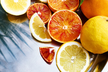 Fototapeta na wymiar Ripe bio sliced oranges and lemons on steel tray top view. Organic Sicilian oranges. Healthy eating concept. Vitamin C