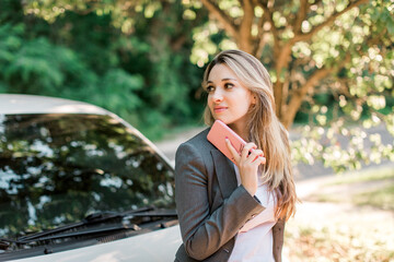 Happy blond pretty woman with smart phone,outdoor.