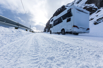 Ein Wohnmobil fährt auf einer schneebedeckten Straße