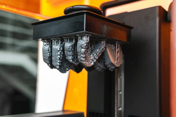 jaw models being printed in resin on a 3d printer in the lab. Model for dental prostheses