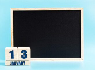 January 13. Day 13 of month, Cube calendar with date, empty frame on light blue background. Place for your text. Winter month, day of the year concept