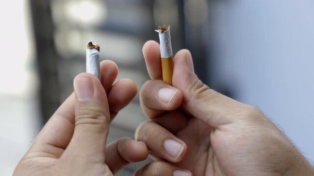 World No Tobacco Day. The young man quit smoking for his good health. He broke a cigarette in two
