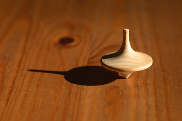 closeup of a spinning top symbolizing a fragile, unstable condition of balance achieved by constant movement like in the business world