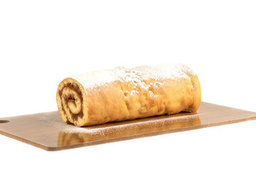 Apple roll or strudel sprinkled with powdered sugar on a cutting board.