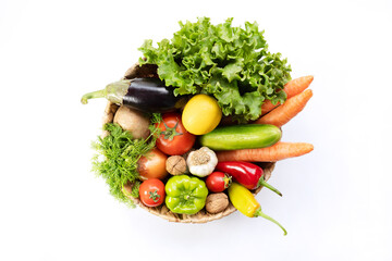 Fresh Vegetables in basket on white isolated background top view.