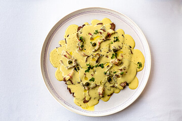 The traditional Italian dish vitello tonato is on the plate.