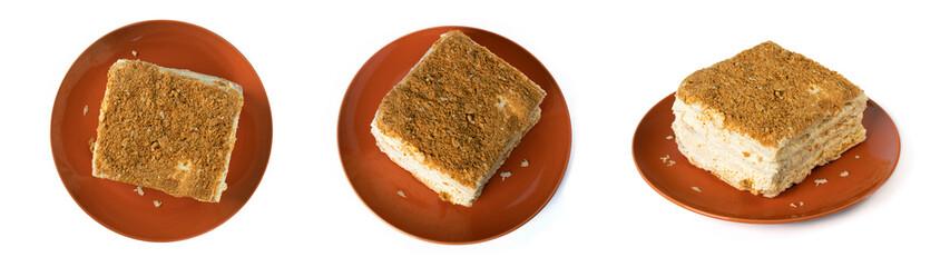 A square piece of Napoleon cake on an orange round plate. Top view. Different camera angles.