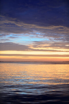 Sunset sea beach. Bright sunrise with yellow horizon under the sea surface.