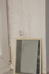 Mirror on the old windowsill. House with an old renovation