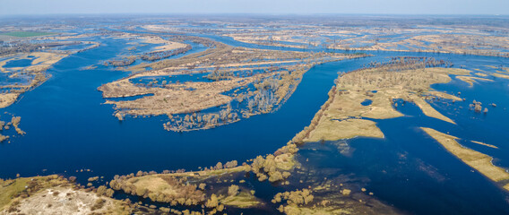 Aerial view of river flood. Beautiful flooded meadow. Flying above beautiful Pripyat river when the river is full of water at spring. Nature concept.