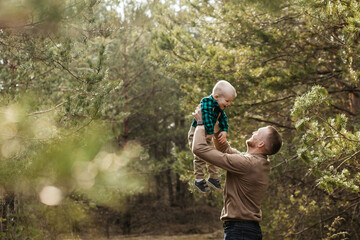 Dad is fooling around with his son. Dad throws his son in the air.Father playing with his son. Happy child. Father's day
