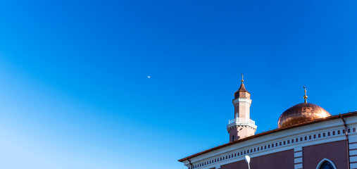Mosque on blue sky background. Muslim worship. Texture and background for design. Space for text.