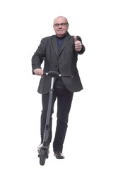 Obraz premium full growth . Mature business man with an electric scooter