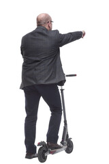 rear view . Mature man leaving on an electric scooter