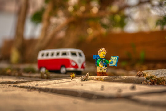 Ontario, Canada - April 10, 2021. Lego hiker parks VW camper at trailhead and checks map and compass before setting off on his next trekking adventure.