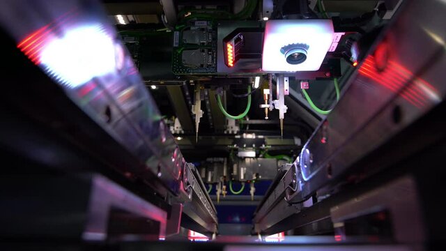 Automatic machine for diagnostics of electronic boards, production. Small needles are checking the electronic circuit. Creation of electronic boards and microcircuits. Processor manufacturing.