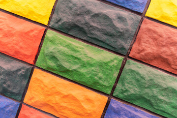 Multicolored decorative tiles are laid diagonally in the shape of a brick