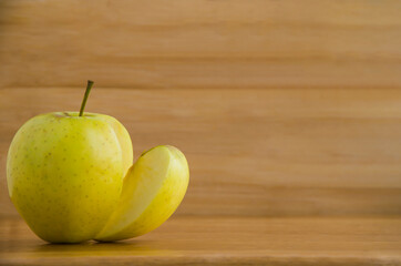 yellow apple on wooden table