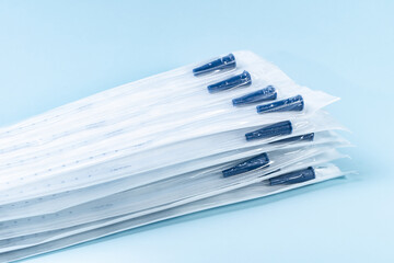 Rusch male and female all purpose catheter on blue background, straight tipped intermittent...