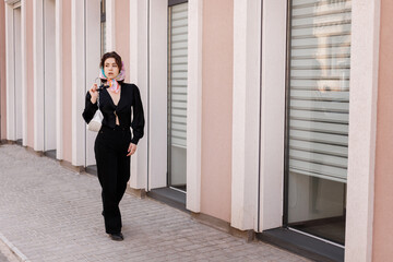 Girl in a headscarf walks through the city