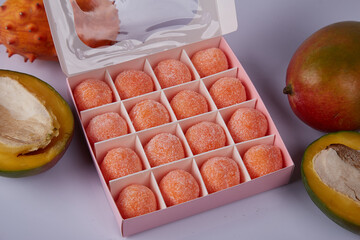 Orange color fresh big box with sweets candy sugar free organic healthy food tasty flavor juicy fruit mango or cosmetic scrub for body skin care.