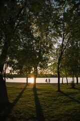 Happy family near the lake at sunset