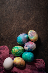 multi-colored Easter eggs of blue tones on a pink cloth background. Easter eggs in low key