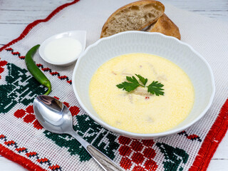 traditional romanian dish tripe soup known as ciorba de burta served with cream and pepper