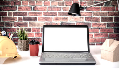 laptop screen at the office table with yellow helmet