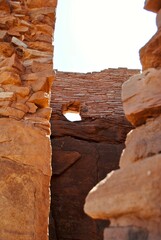 Wupatki National Monument and the Wupatki (tall house) pueblo. The dwelling's walls were constructed from thin, flat blocks of the local Moenkopi sandstone, giving the pueblo its distinct red color.