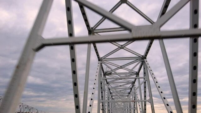 Slow motion footage of metal latticework overhead construction on the central part of Chesapeake Bay Bridge, a.k.a William Preston Lane Memorial bridge, connecting  DC region to eastern shore Maryland
