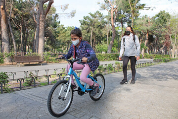 Fototapeta premium Girl riding a bicycle in a park