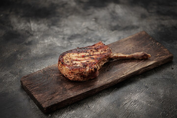 Grilled pork meat with bone on wooden board