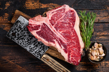 Italian Florentine T-bone beef meat Steak with herbs on a wooden cutting board. Dark wooden background. Top view - Powered by Adobe