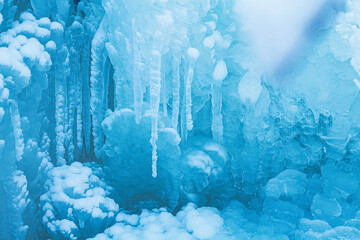 Macro background of snow and icicles. Close-up winter landscape. Beautiful blue ice and snow formations.