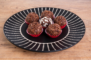 brigadiers in black dish on wooden table