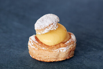 Close-up of appetizing puff pastry cake filled with custard.