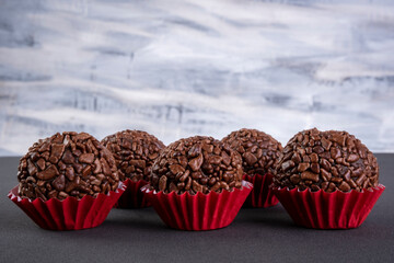 brigadeiros on black table with multicolor background
