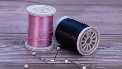 closeup of pink and blue sewing thread