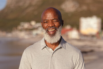 Portrait of senior african american man smiling while standing on the beach