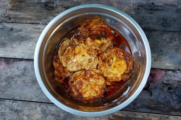 fried egg with soy sauce on wood, a typical Indonesian food