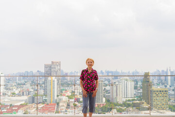 Portrait of a senior woman outdoors during summer at rooftop with copy space