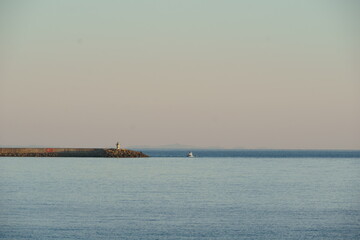 Small boat cruising near the lighthouse