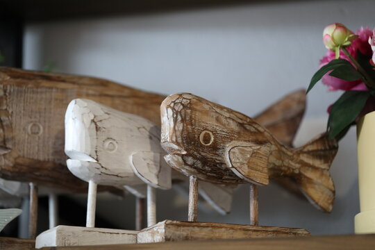 Wooden Carved Whale Statues On Display In Boutique Fashion Store