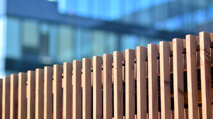 Fragment of a wooden roof against the backdrop of a modern glass facade