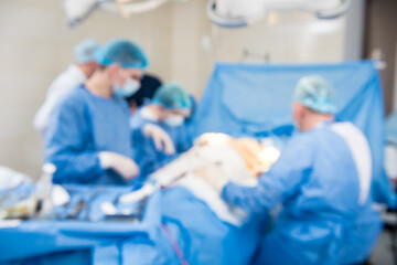 Blurred background of the operating room and the team of surgeons