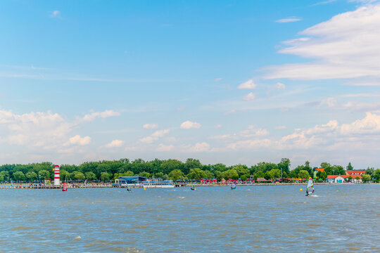 Young people are kite surfing on the neusiedlersee lake in Austria near Podersdorf am See town.