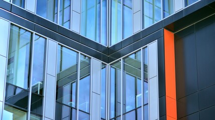 Obraz premium The glazed facade of an office building with reflected sky. Modern architecture buildings exterior background. Clouds sky reflection.